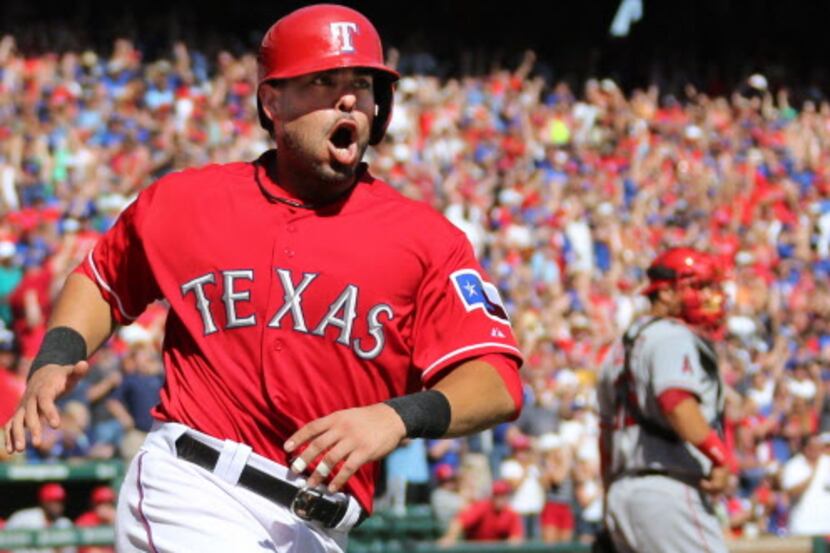 Texas catcher Geovanny Soto celebrates as he scores on Craig gentry's fifth inning hit to...