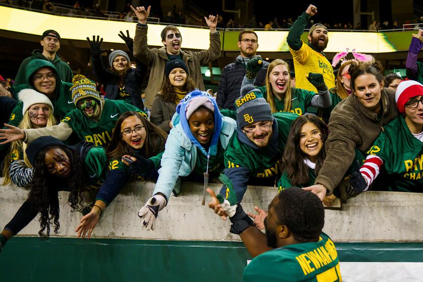 Baylor offensive lineman Xavier Newman (55) celebrates with fans after a victory over West...