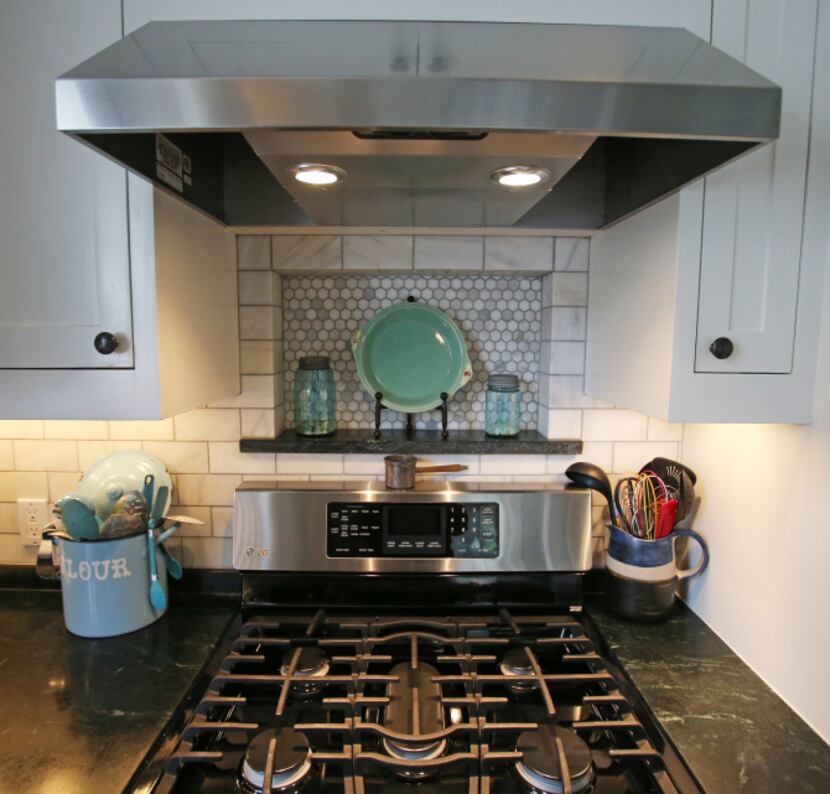 The backsplash in the remodeled kitchen of Jackie and Doug Sweat's home on Junius Street in...