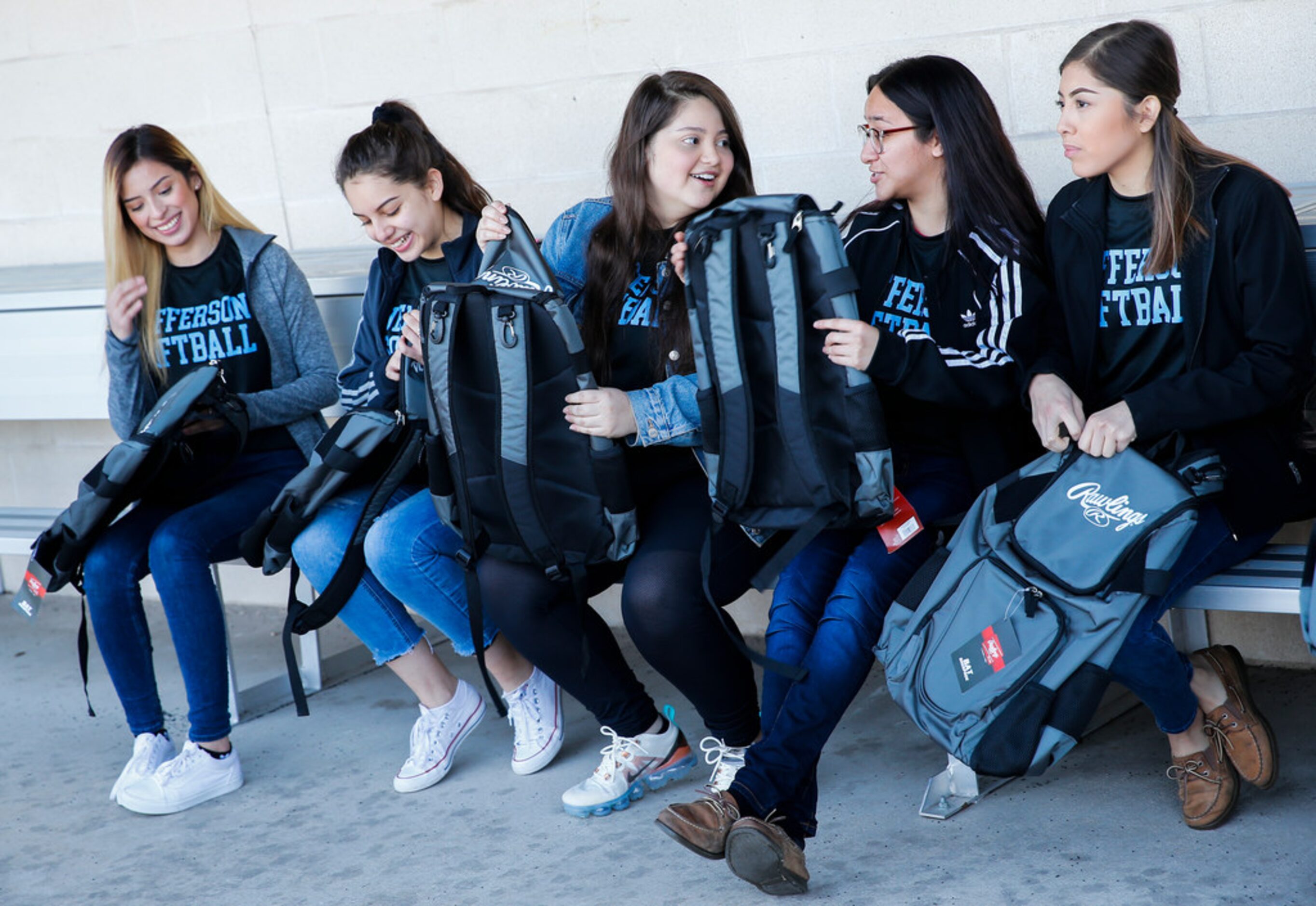 Thomas Jefferson High School softball players react after receiving a donation from Rangers...