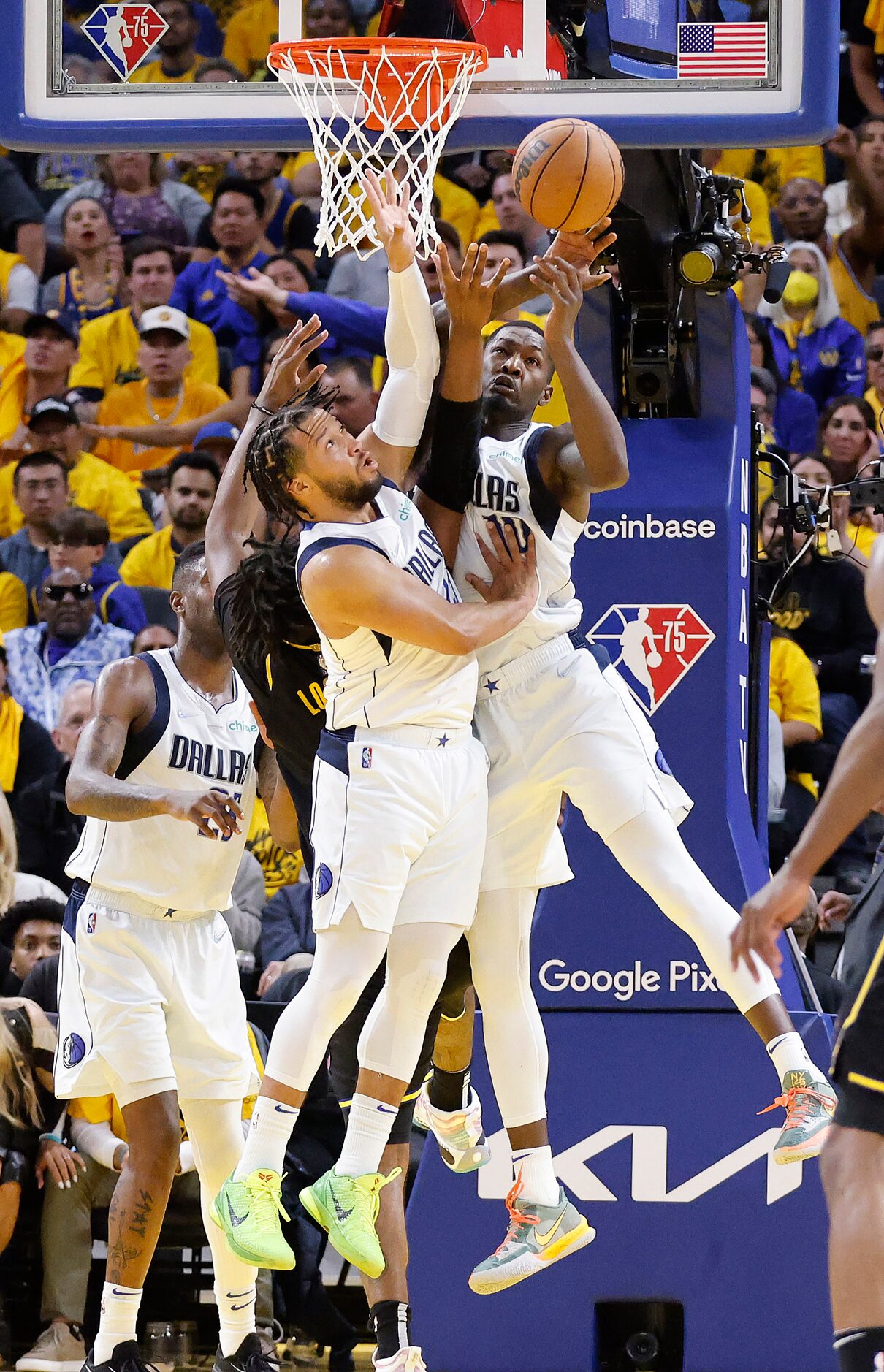 Dallas Mavericks guard Jalen Brunson (13) and forward Dorian Finney-Smith (10) battle for a...