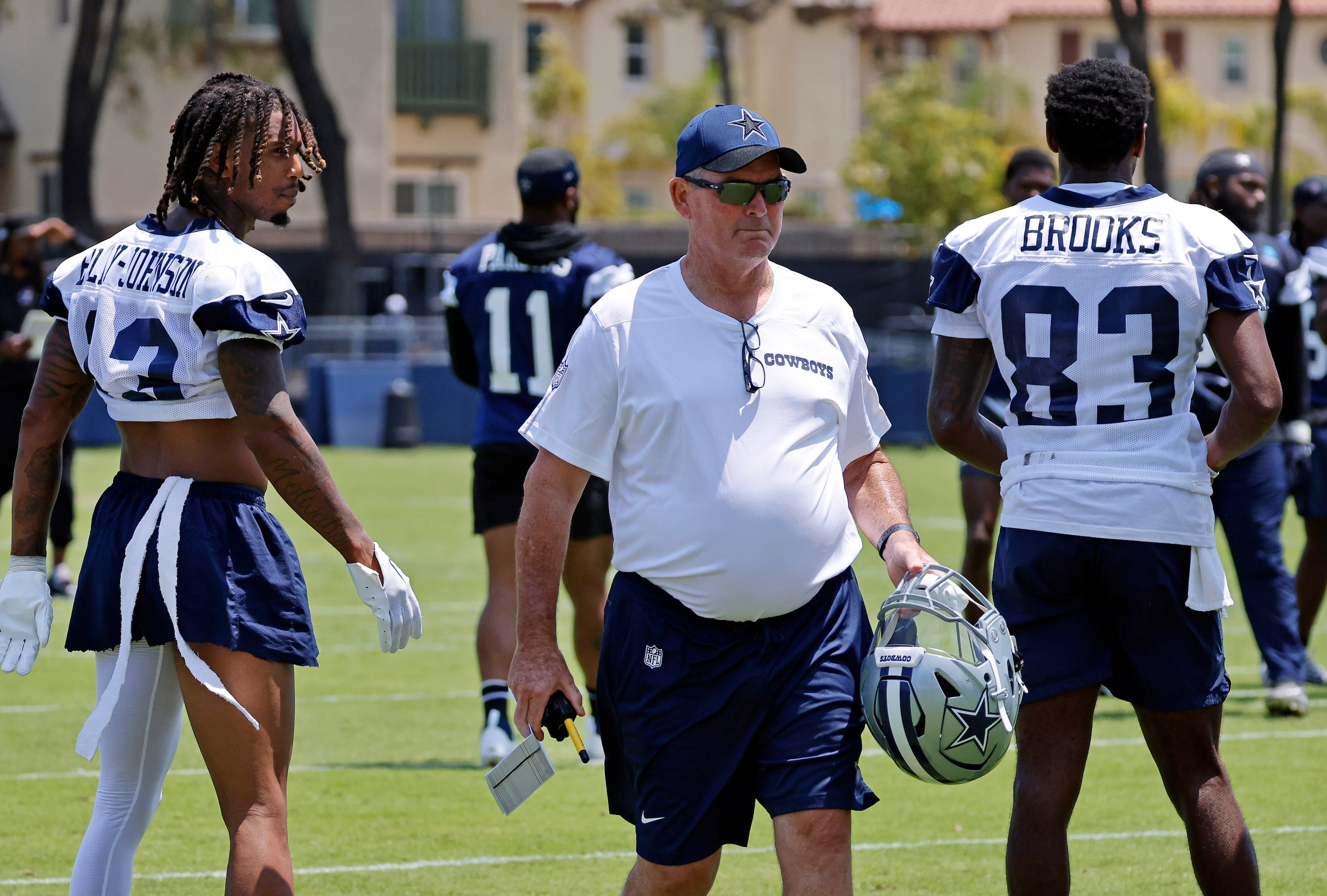 Dallas Cowboys defensive coordinator Mike Zimmer carries linebacker Micah Parsons (11)...