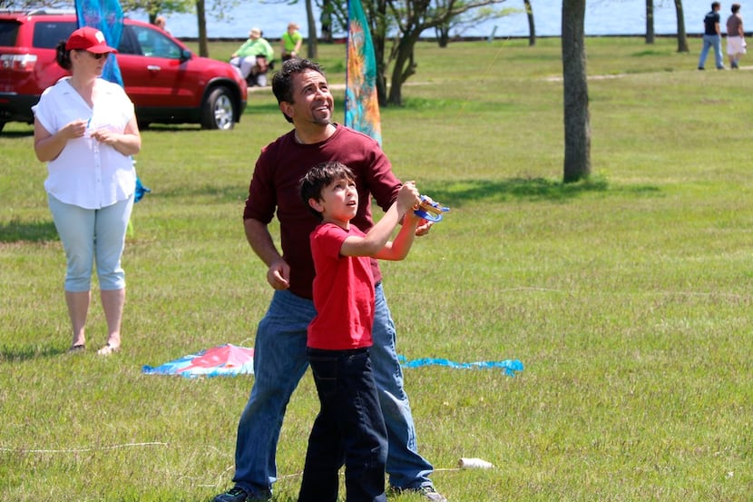 A father and son experience the joy of flying a kite together.