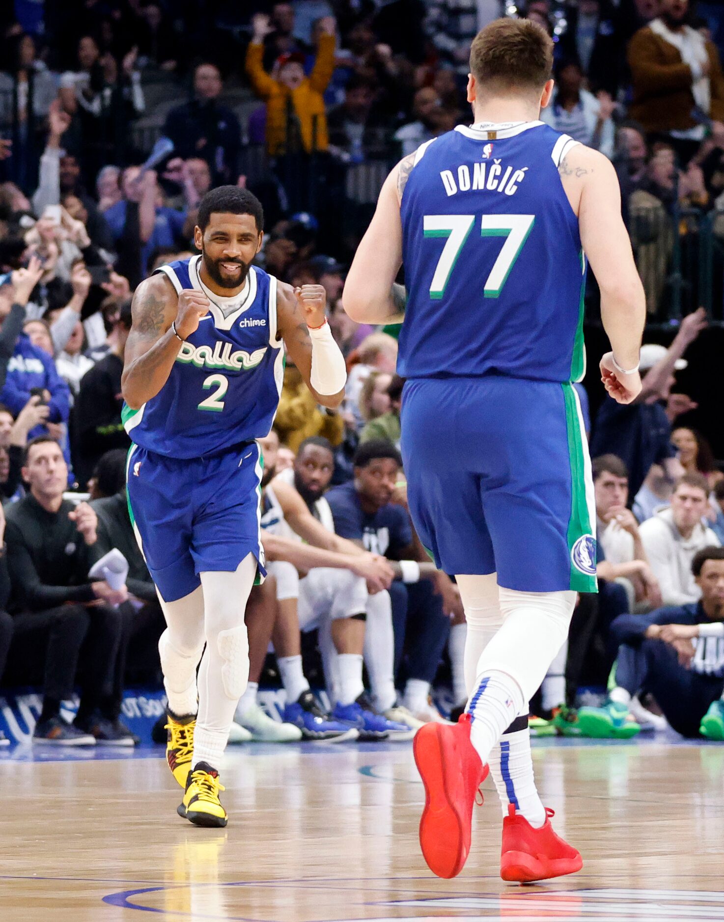 Dallas Mavericks guard Kyrie Irving (2) rects after guard Luka Doncic (77) nailed a...