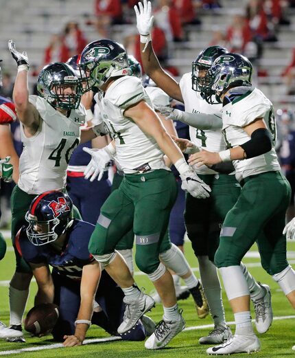 The Prosper defense celebrates sacking McKinney Boyd quarterback Christian Ziegler late in...