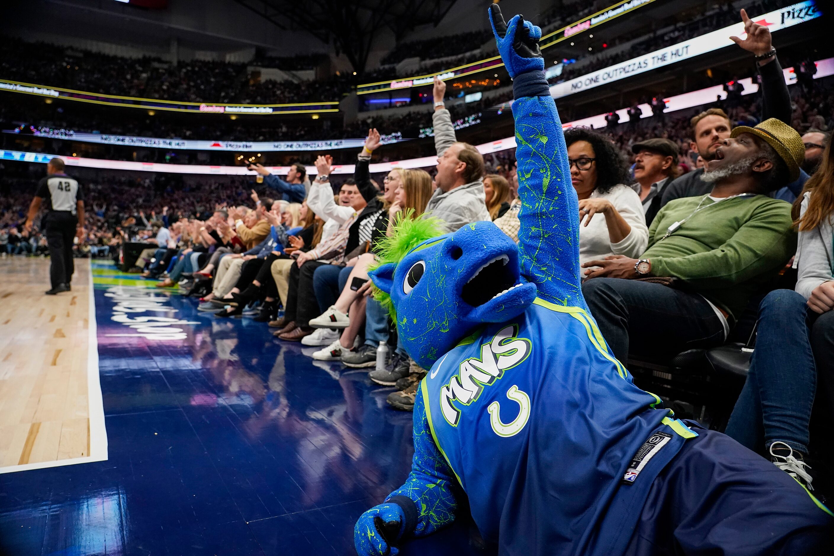 Dallas Mavericks mascot Champ celebrates a 3-pointer by forward Kristaps Porzingis during...