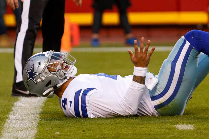 Dallas Cowboys quarterback Dak Prescott (4) reacts after being knocked to the ground by...