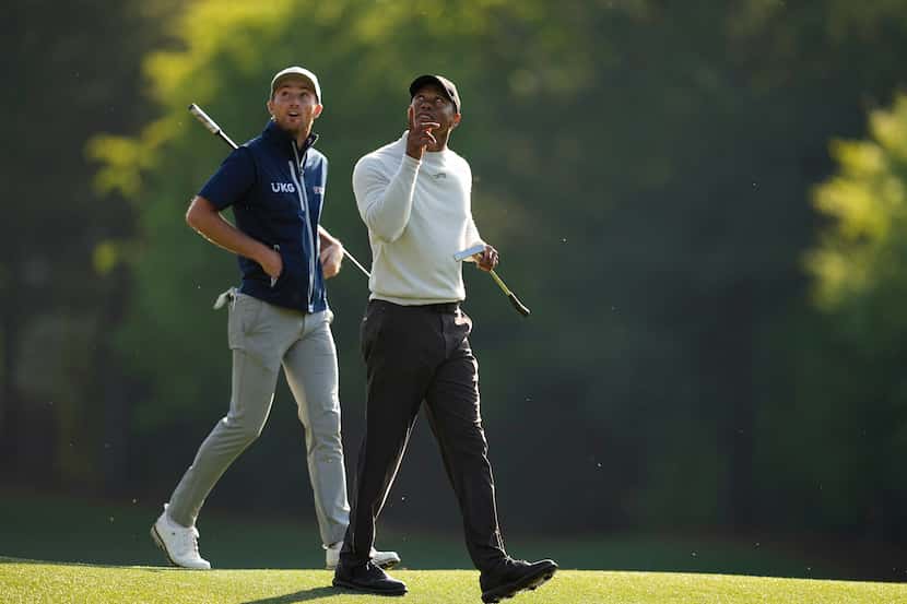 Will Zalatoris, left, and Tiger Woods walk to the12th green during a practice round in...