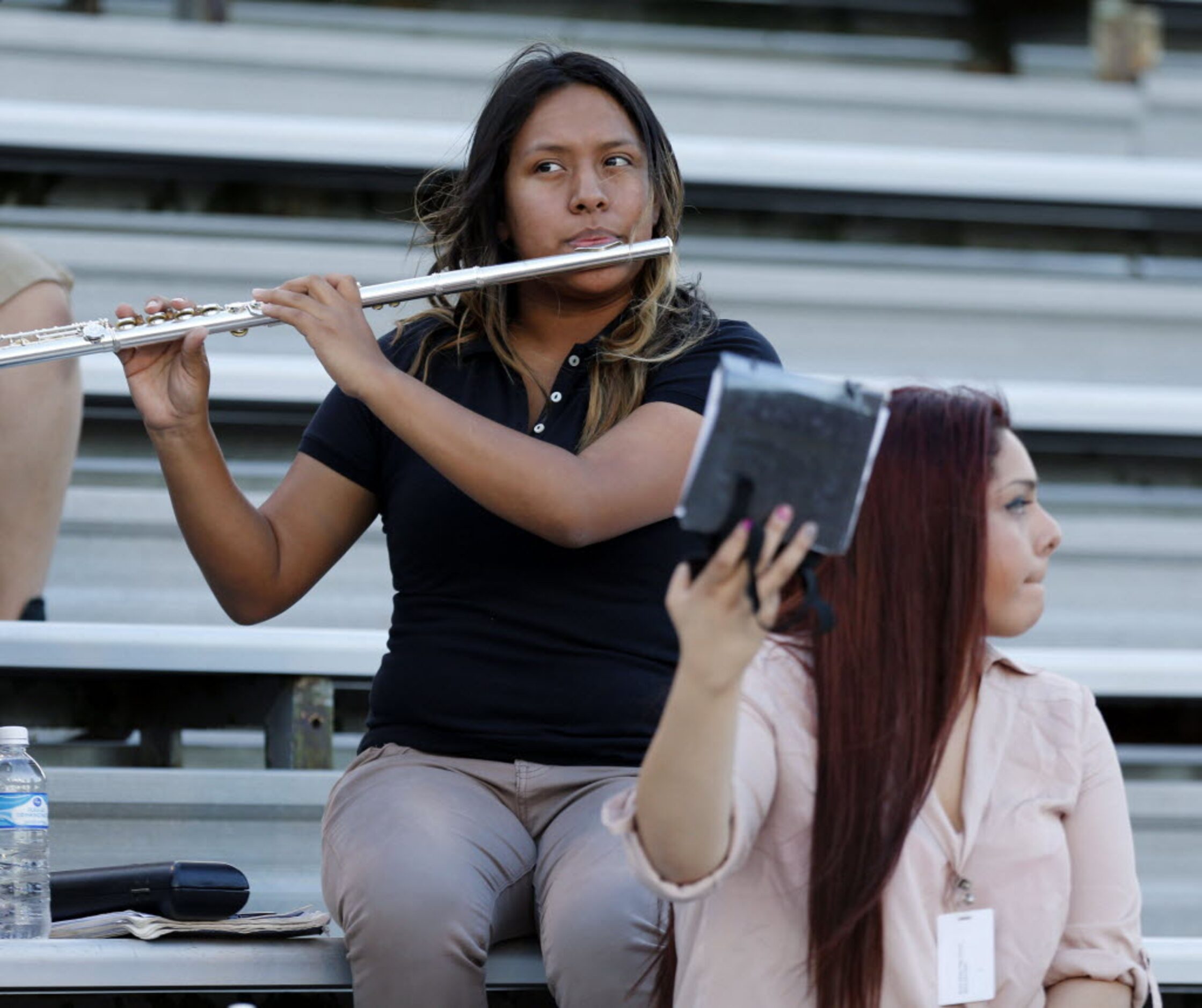 (TXHSFB) North Dallas High member Mayra Gonzalez, 17, a senior, plays her flute, as field...