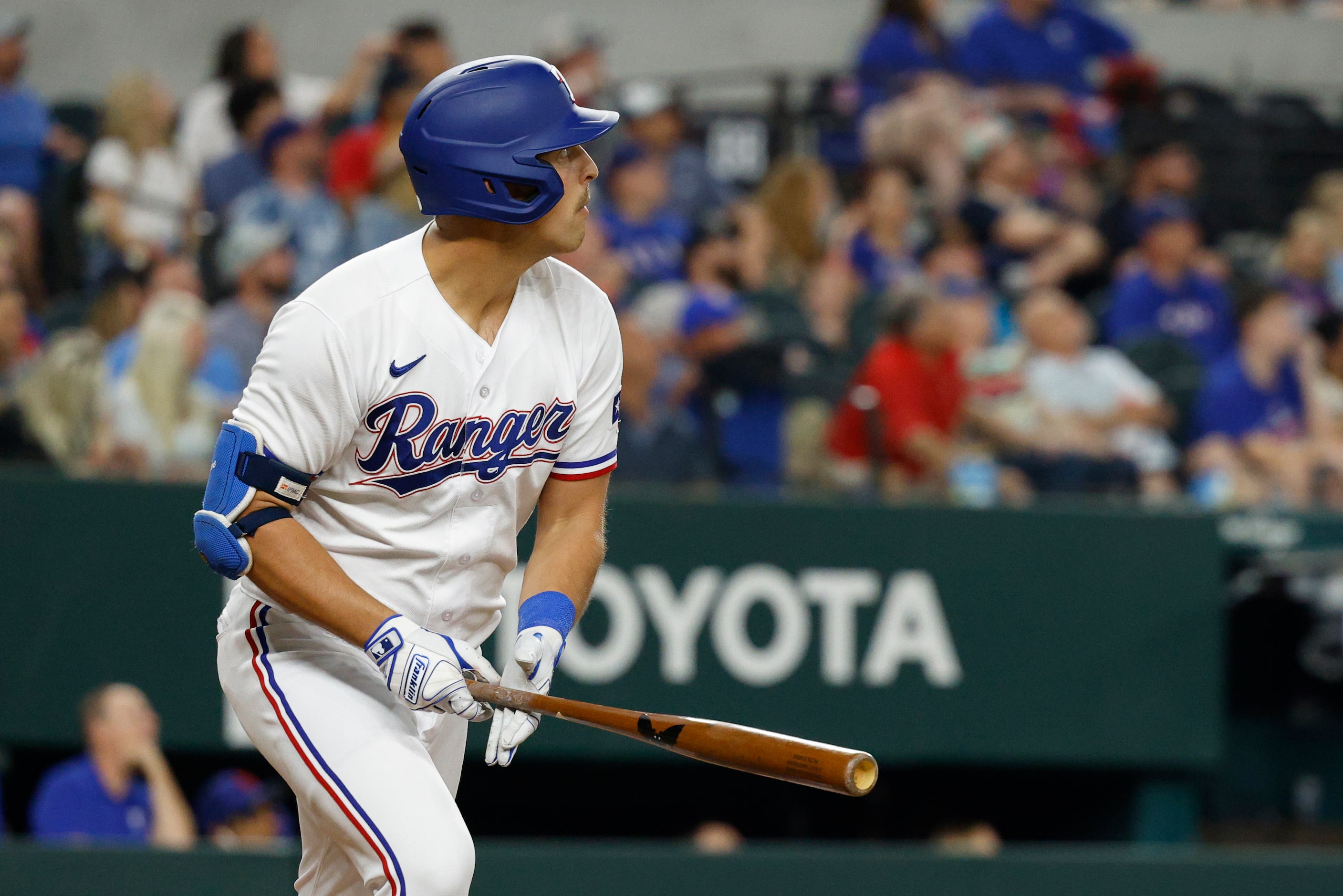 Texas Rangers first baseman Nathaniel Lowe (30) watches the ball after hitting a home run...