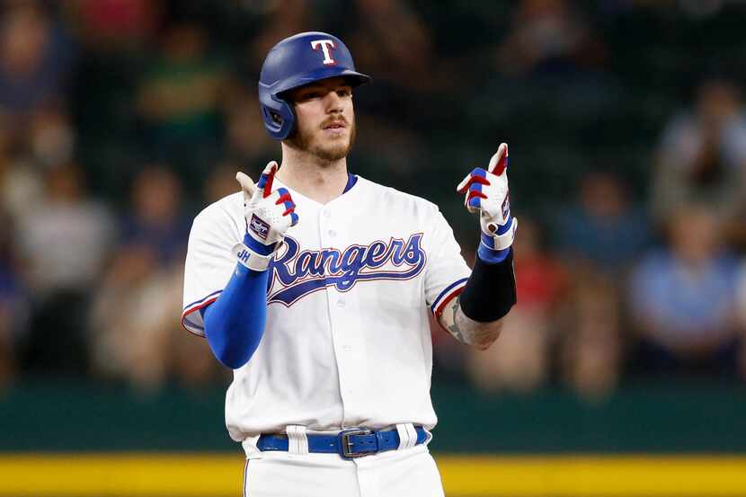 Texas Rangers catcher Jonah Heim (28) gestures to the Rangers dugout after double to right...
