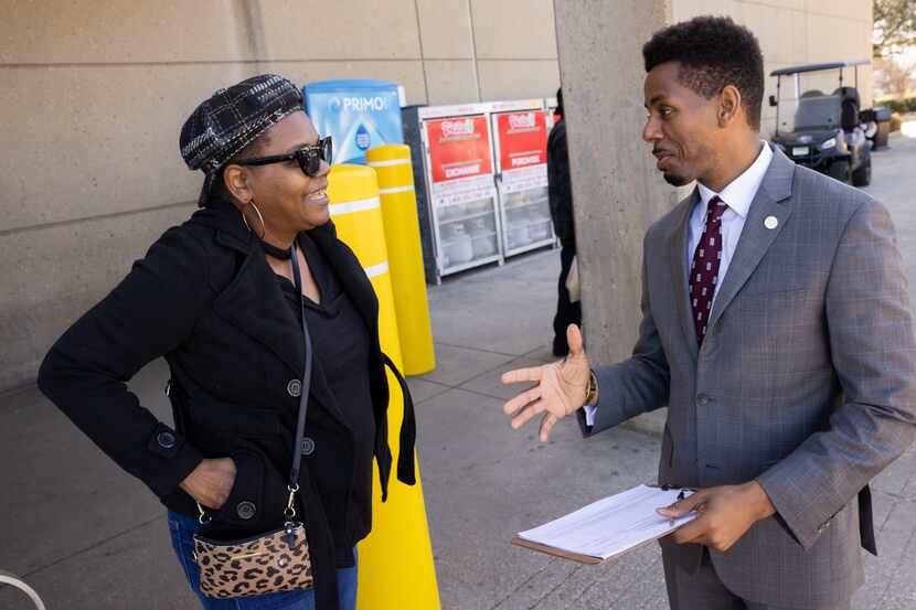 Jrmar Jefferson (right) with a potential voter in February 2023 in South Dallas.