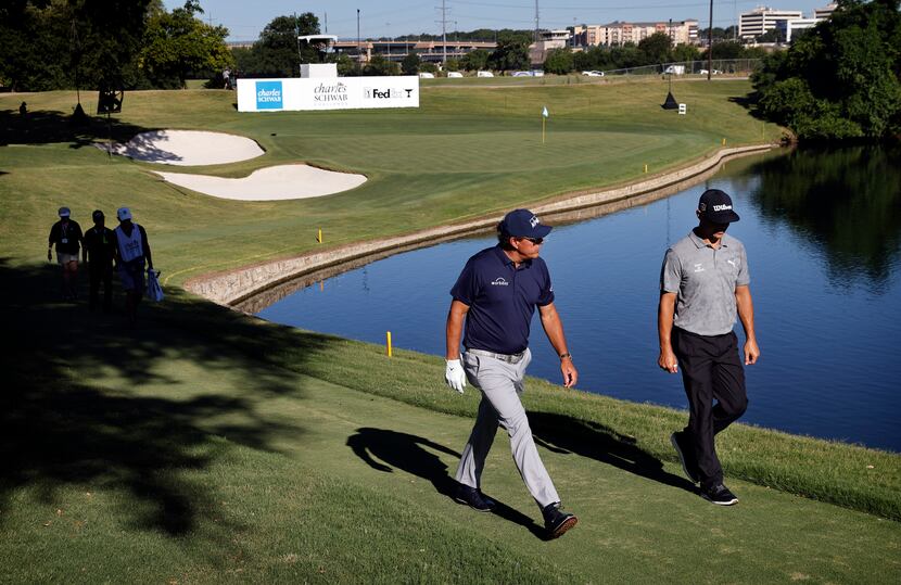 After finishing the par-3 No. 13, PGA Tour golfers Gary Woodland (right) and Phil Mickelson...
