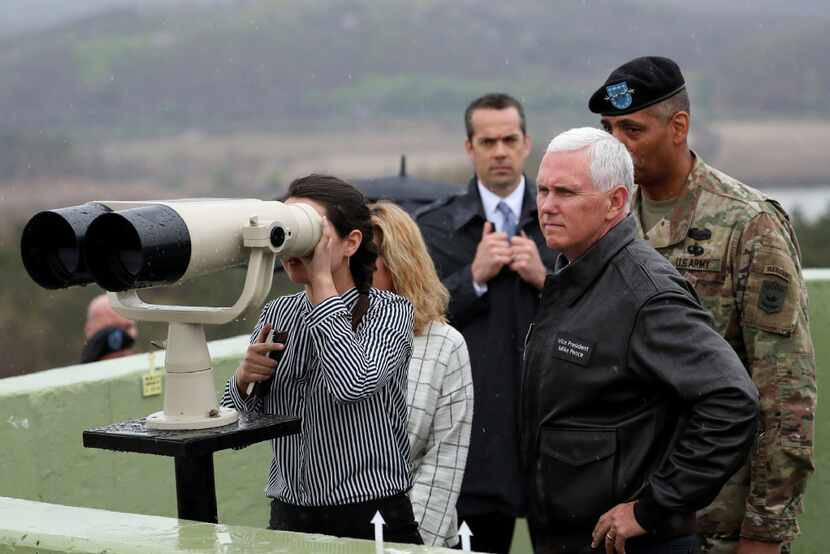 Vice President Mike Pence (right) looks toward North Korea side as his daughter uses...