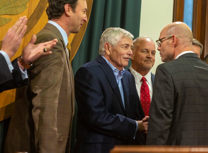 At center, Rep. Tom Craddick, R-Midland, shakes hands with Rep. Dennis Bonnen, R-Angleton,...