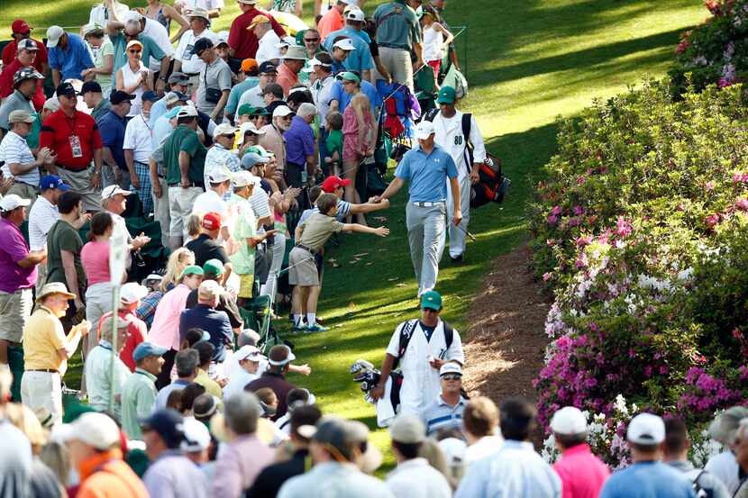 Apr 11, 2015; Augusta, GA, USA; Jordan Spieth high-fives to young patrons along the 6th hole...