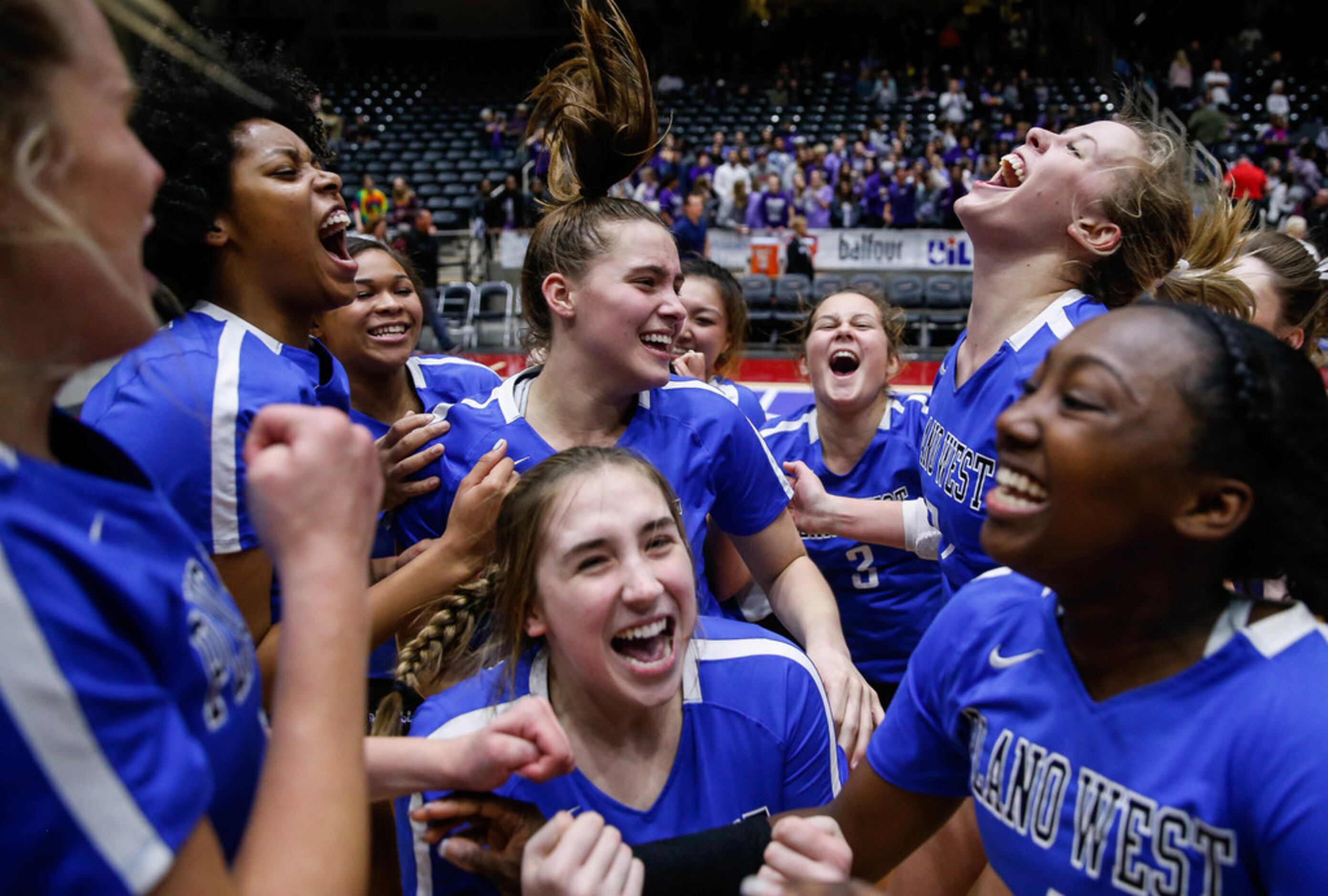 The Plano West Wolves celebrate after winning the fifth and final set during a class 6A...