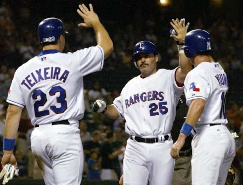 Texas Rangers designated hitter Rafael Palmeiro (25) celebrates his home run against the...