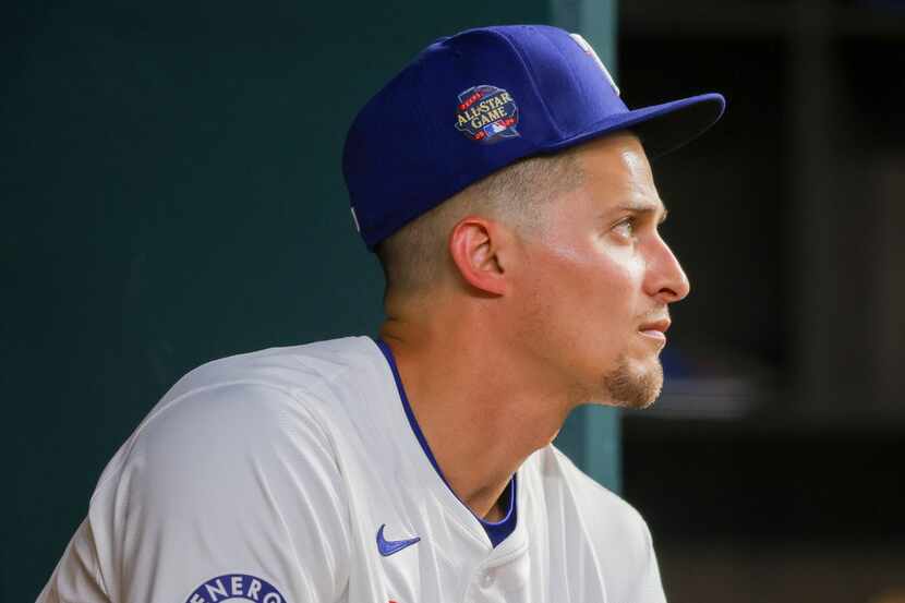 Texas Rangers' Corey Seager sits in the dugout before a baseball game against the Seattle...