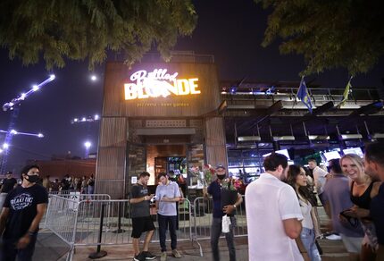 People gather outside Bottled Blonde in the Deep Ellum area of Dallas on Aug. 28, 2020. Soon...