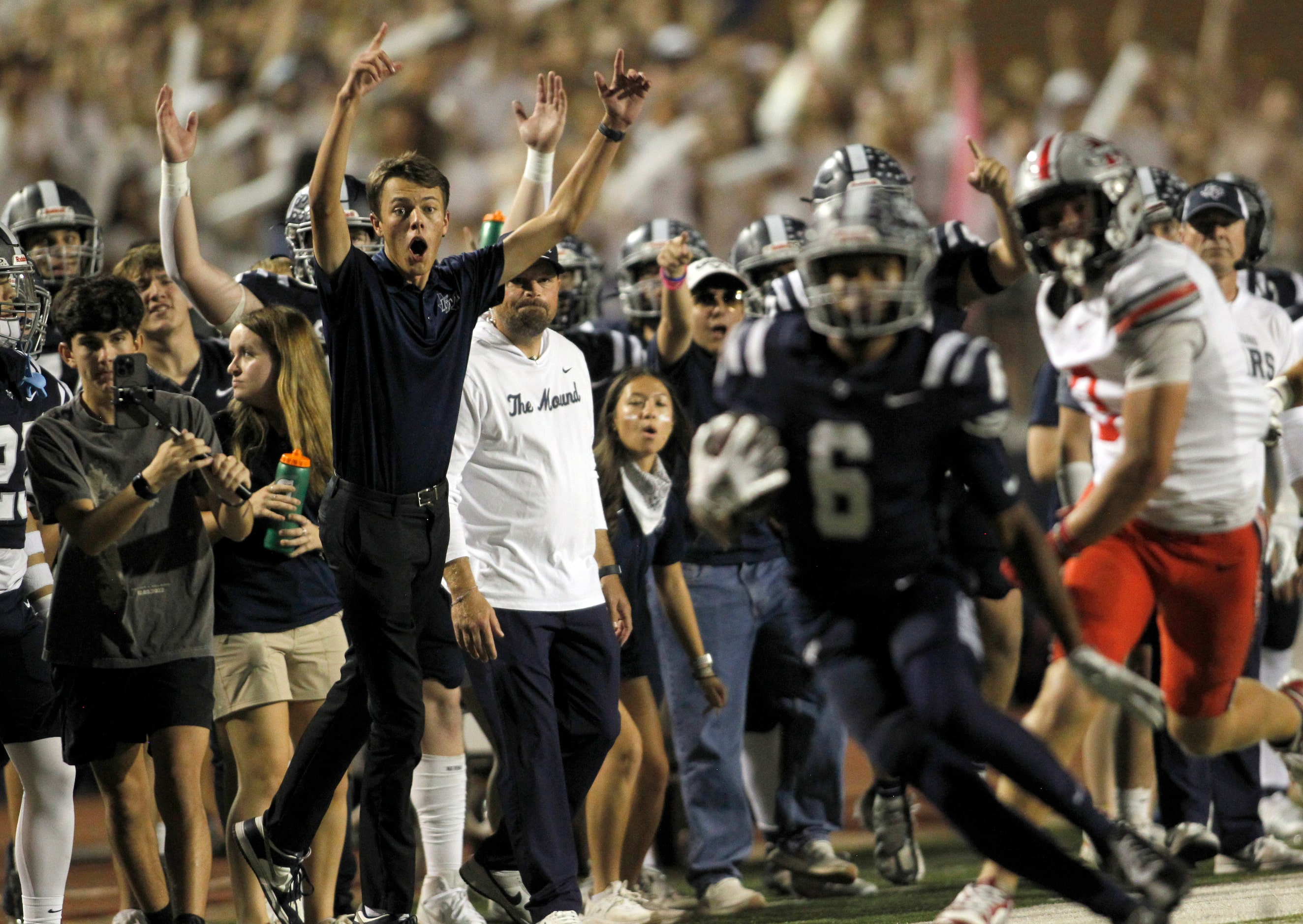 Flower Mound receiver Trey Brown (6) ignites the Jaguars bench as he tacks yardage onto a...