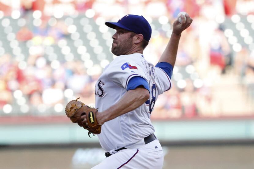 Texas Rangers starting pitcher Colby Lewis (48) throws during the first inning at Globe Life...