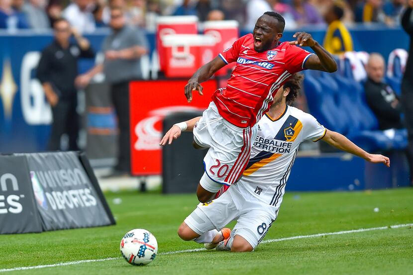 Los Angeles Galaxy midfielder Joao Pedro (8), of Portugal, trips FC Dallas forward Roland...