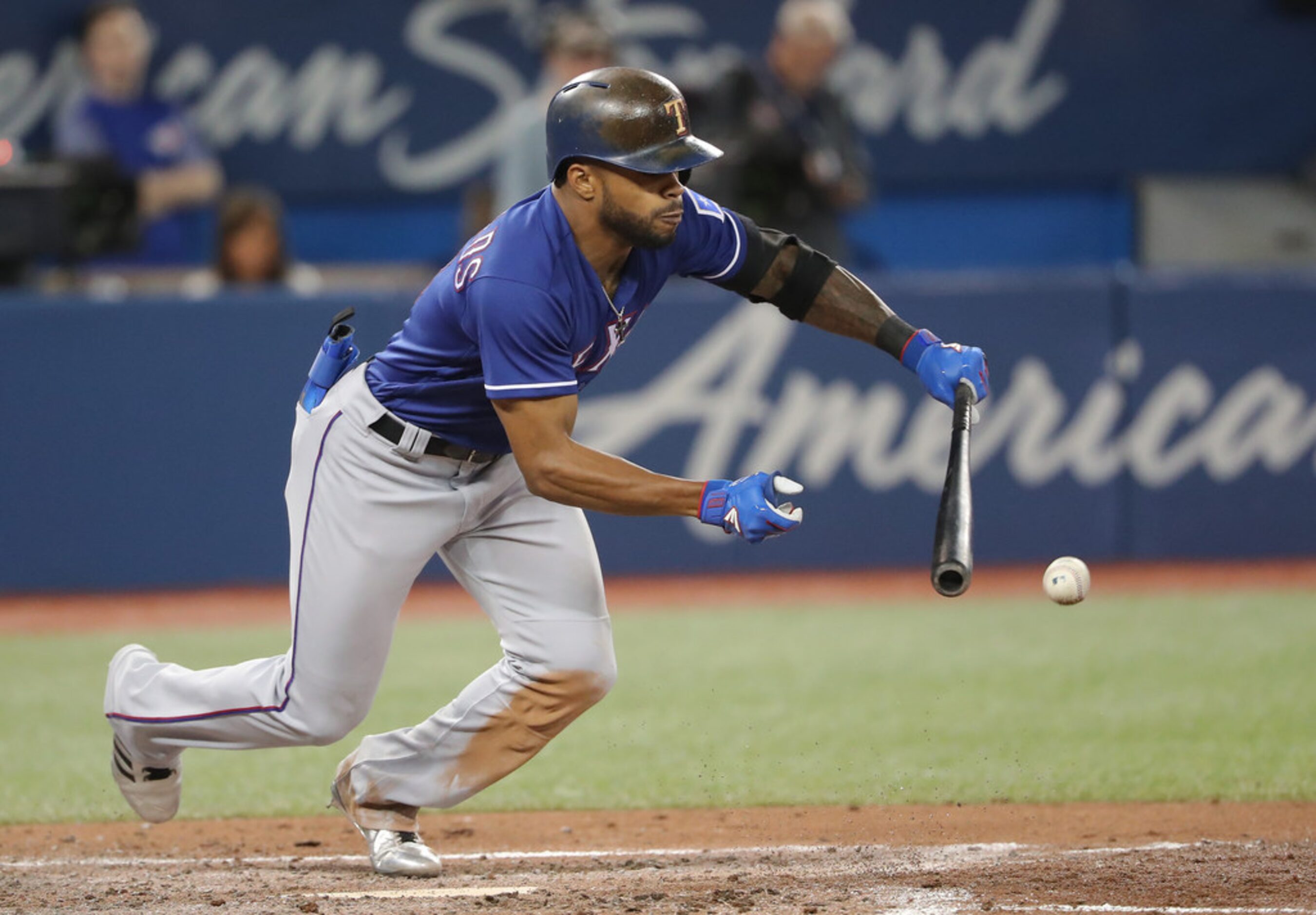 TORONTO, ON - APRIL 27: Delino DeShields #3 of the Texas Rangers lays down a sacrifice bunt...