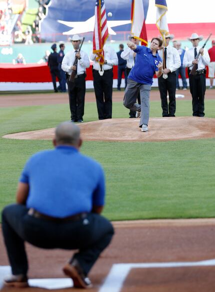 Arlington Mayor Jeff Williams throws the first pitch to Former Texas Rangers catcher Ivan...
