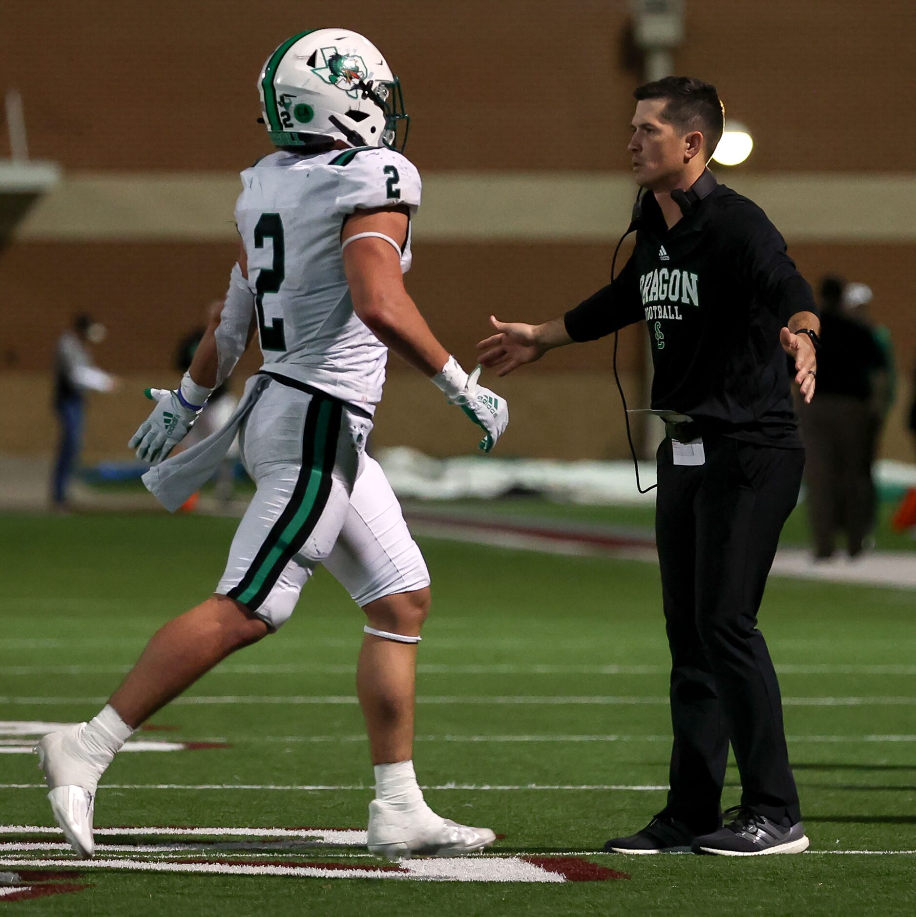 Southlake Carroll head coach Riley Dodge greets running back Owen Allen (2) after a...