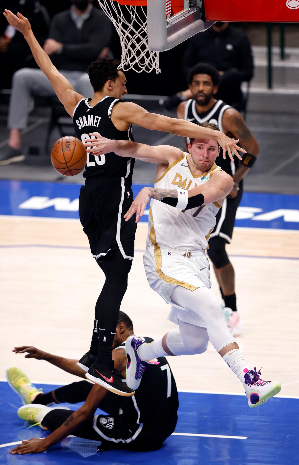 Dallas Mavericks guard Luka Doncic (77) passes the ball off as he drove past Brooklyn Nets...