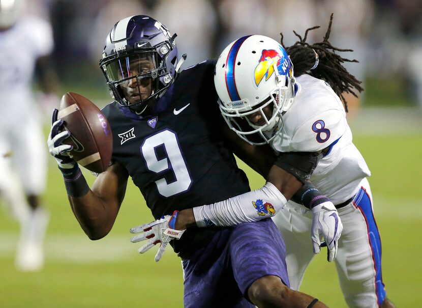 TCU Horned Frogs wide receiver John Diarse (9) is tackled by Kansas Jayhawks cornerback...