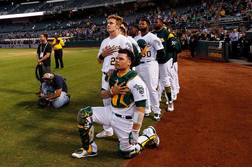 OAKLAND, CA - SEPTEMBER 25:  Bruce Maxwell #13 of the Oakland Athletics kneels during the...