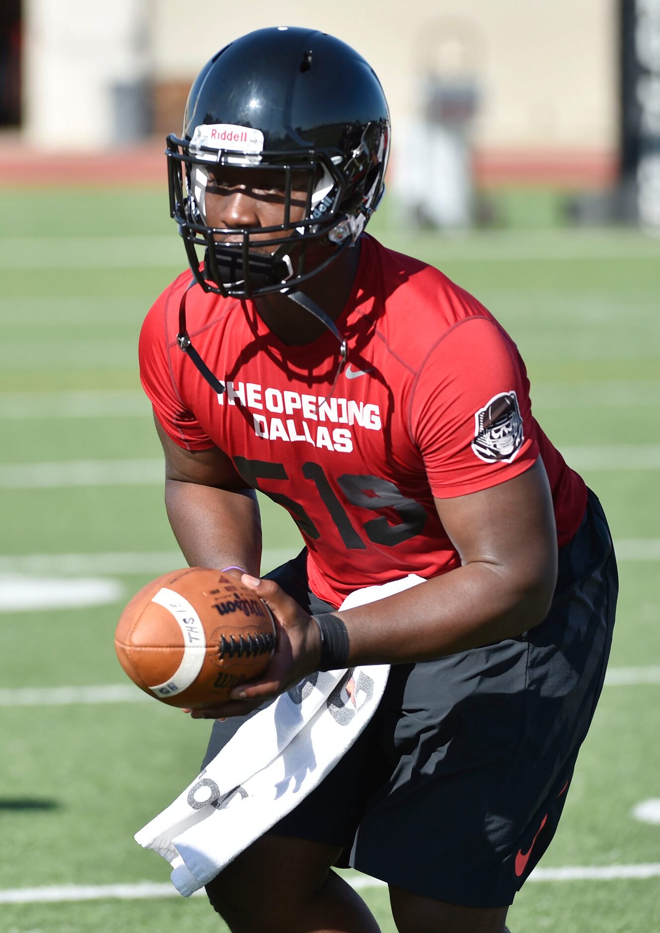 Quarterback Tyler Natee runs a play during Euless Trinity's first day of football practice...