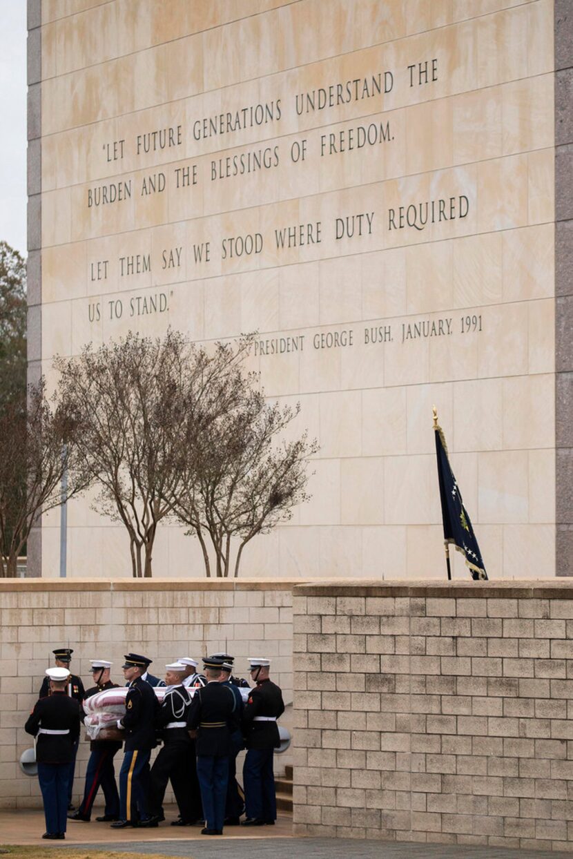 The flag-draped casket of President George H.W. Bush is carried to a burial plot close to...