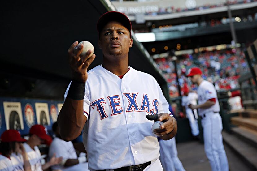 Texas Rangers third baseman Adrian Beltre signs autographs for fans before a 14-3 win over...