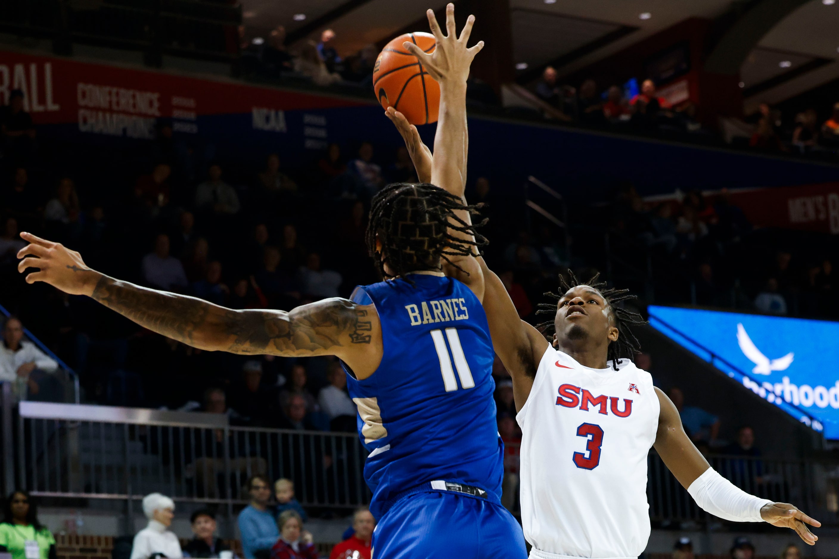 Tulsa guard Isaiah Barnes (11) reaches to block Southern Methodist guard Chuck Harris during...