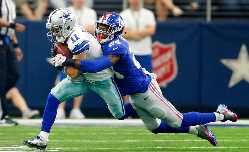 Dallas Cowboys wide receiver Cole Beasley (11) is tackled by New York Giants cornerback Eli...