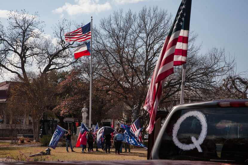 A Q-Anon symbol is displayed on a car as New Braunfels Trump Train members meet in support...