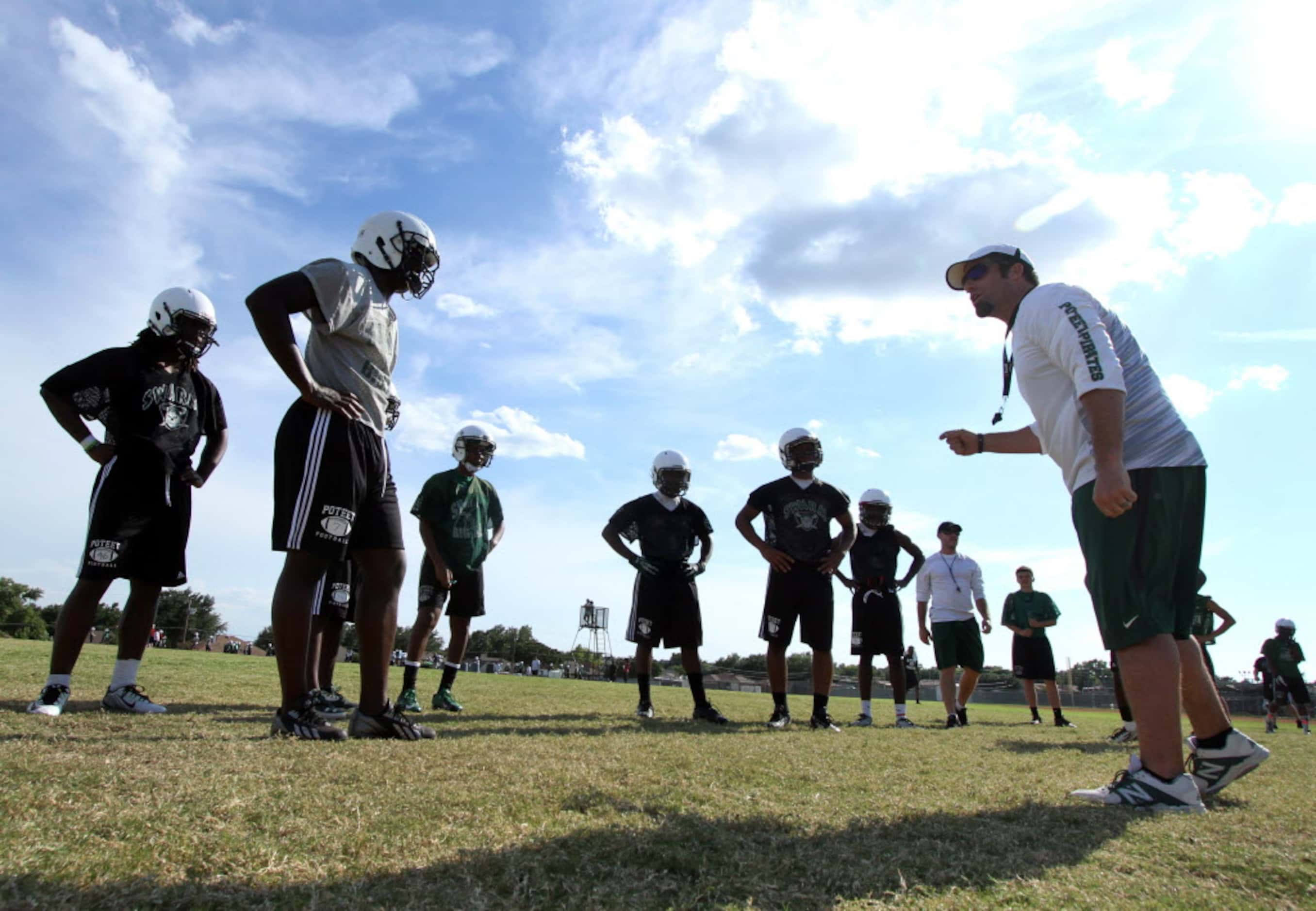 Mesquite Poteet defensive line coach David Lynch directs players through an opening day...