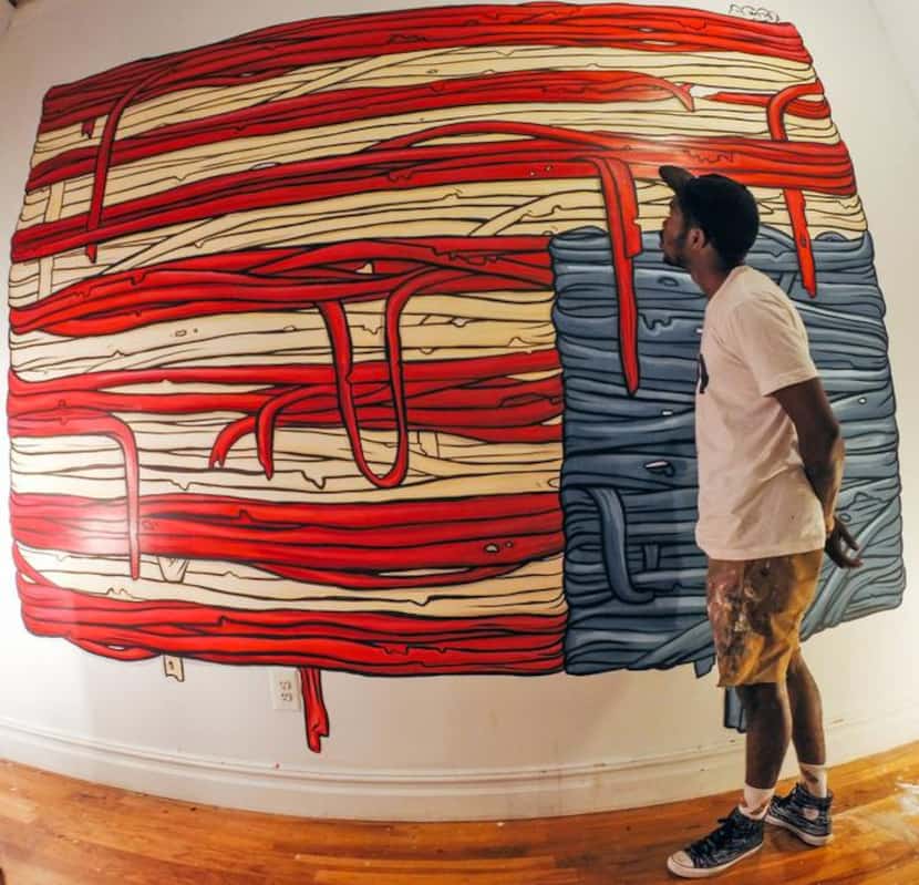 
Bryan Blue stands in front of a painting he was commissioned to create earlier this year in...