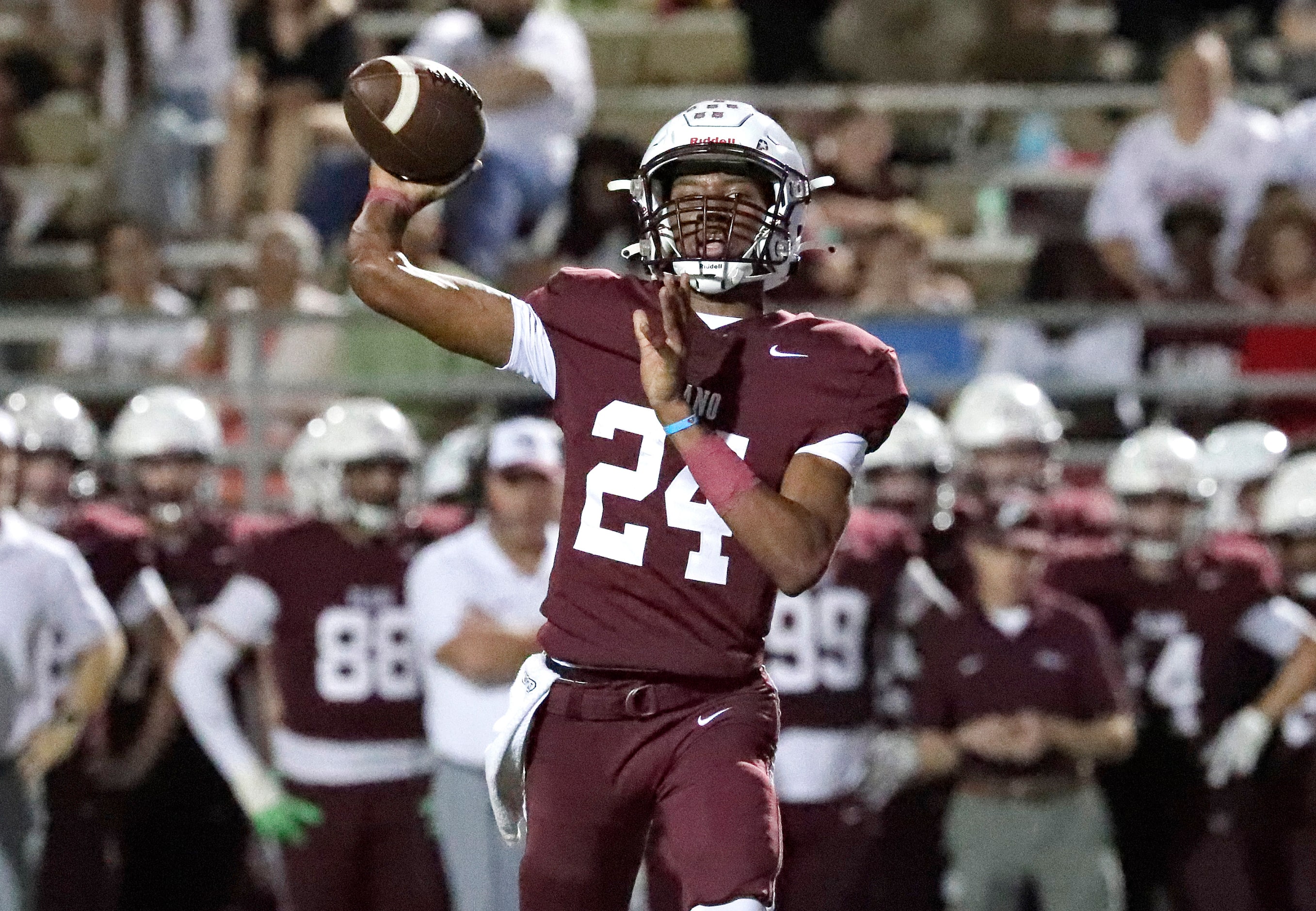 Plano High School quarterback Tyree Fisher (24) throws a pass during the first half as Plano...