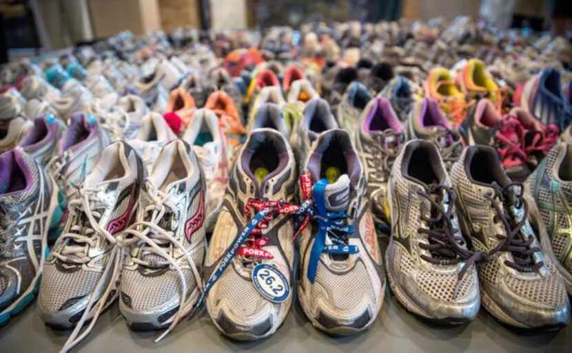 
Running shoes are laid out en masse at the Boston Public Library display. The surviving...