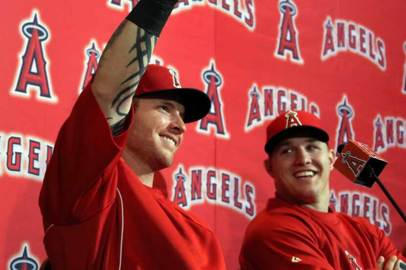 Angels' outfielder Josh Hamilton clowns around with teammate Mike Trout during a press...