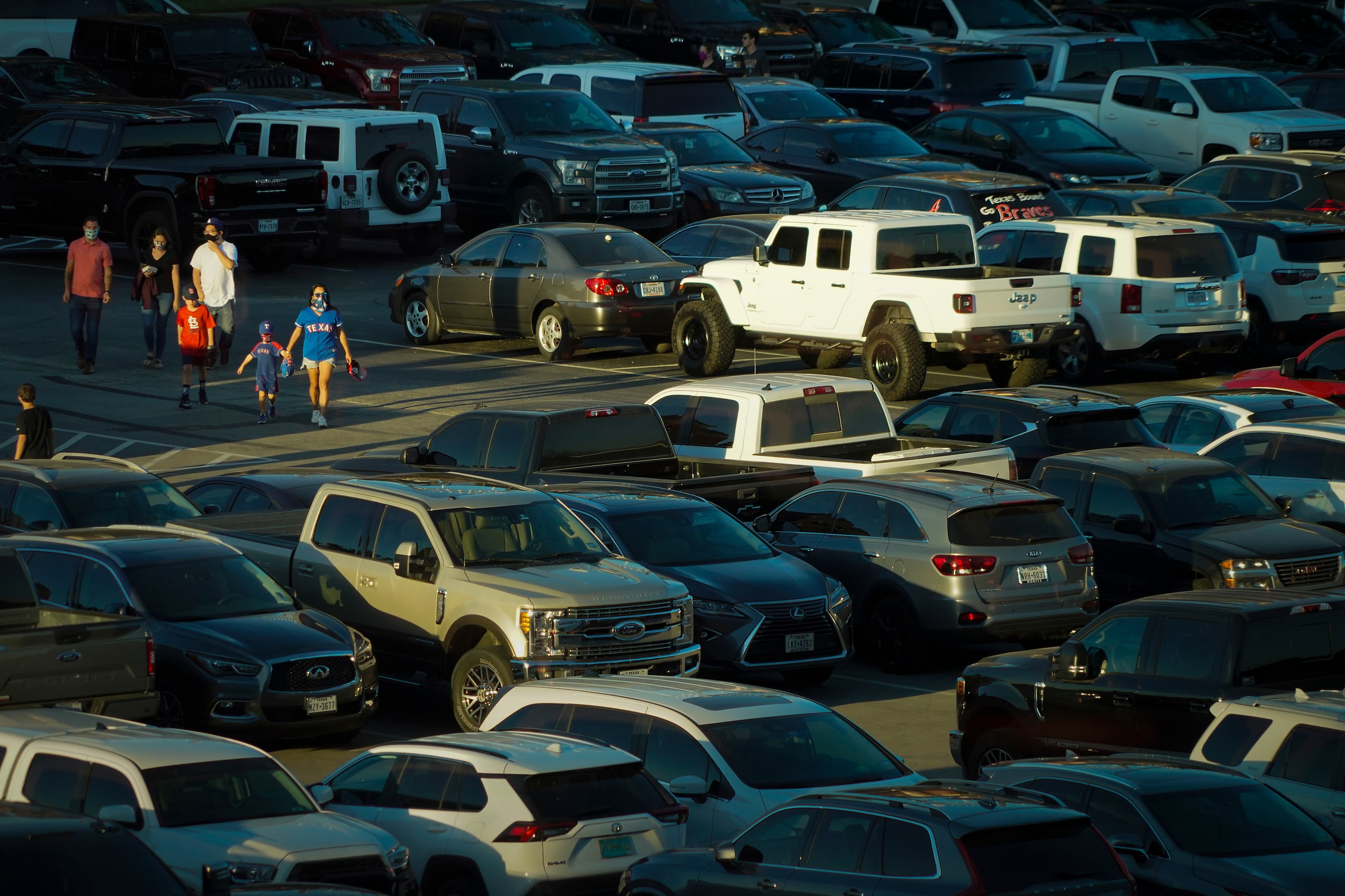 Fans head to the stadium from the parking lot before Game 1 of a National League...