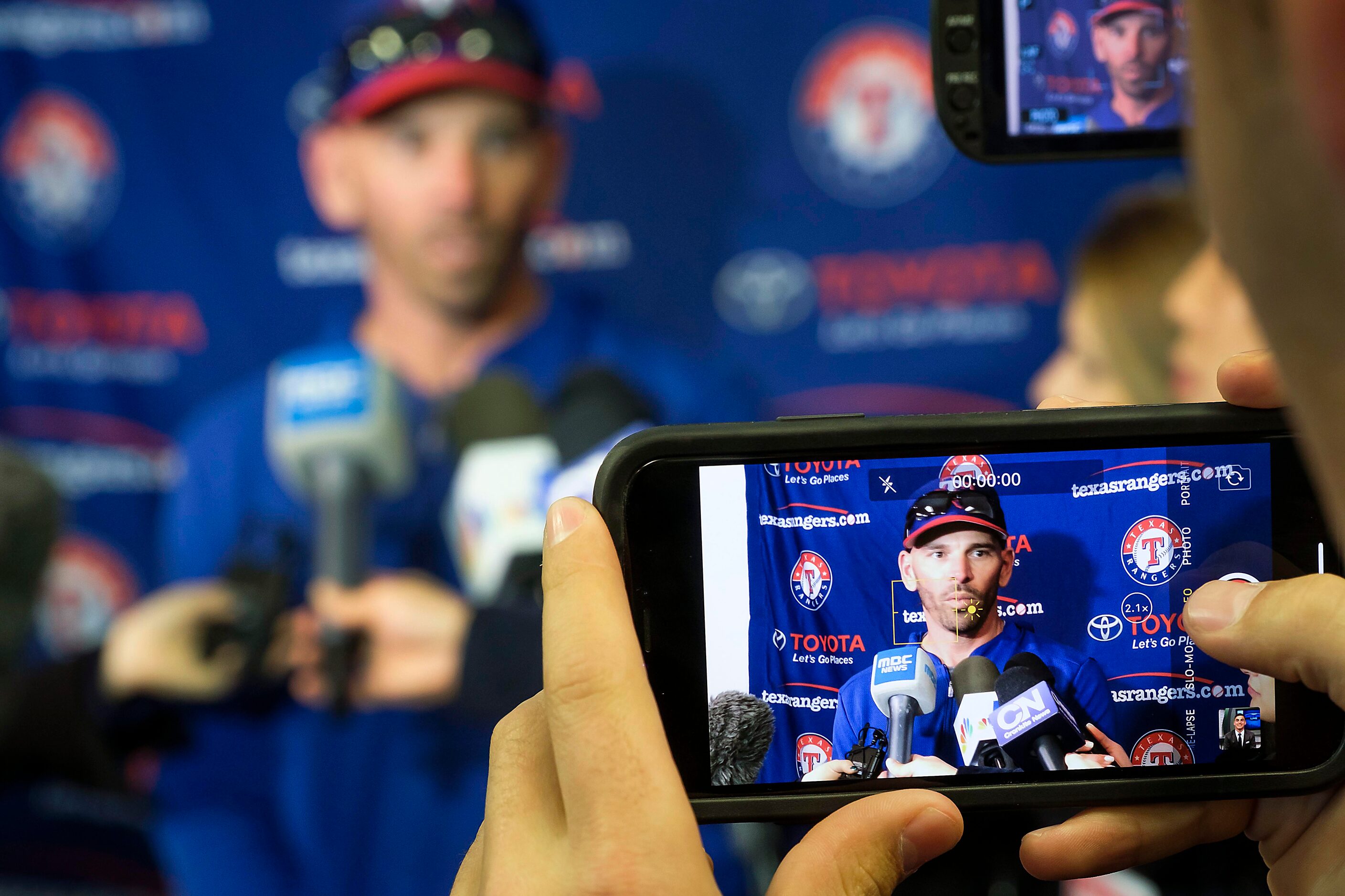 Texas Rangers manager Chris Woodward addresses the media before a spring training workout at...