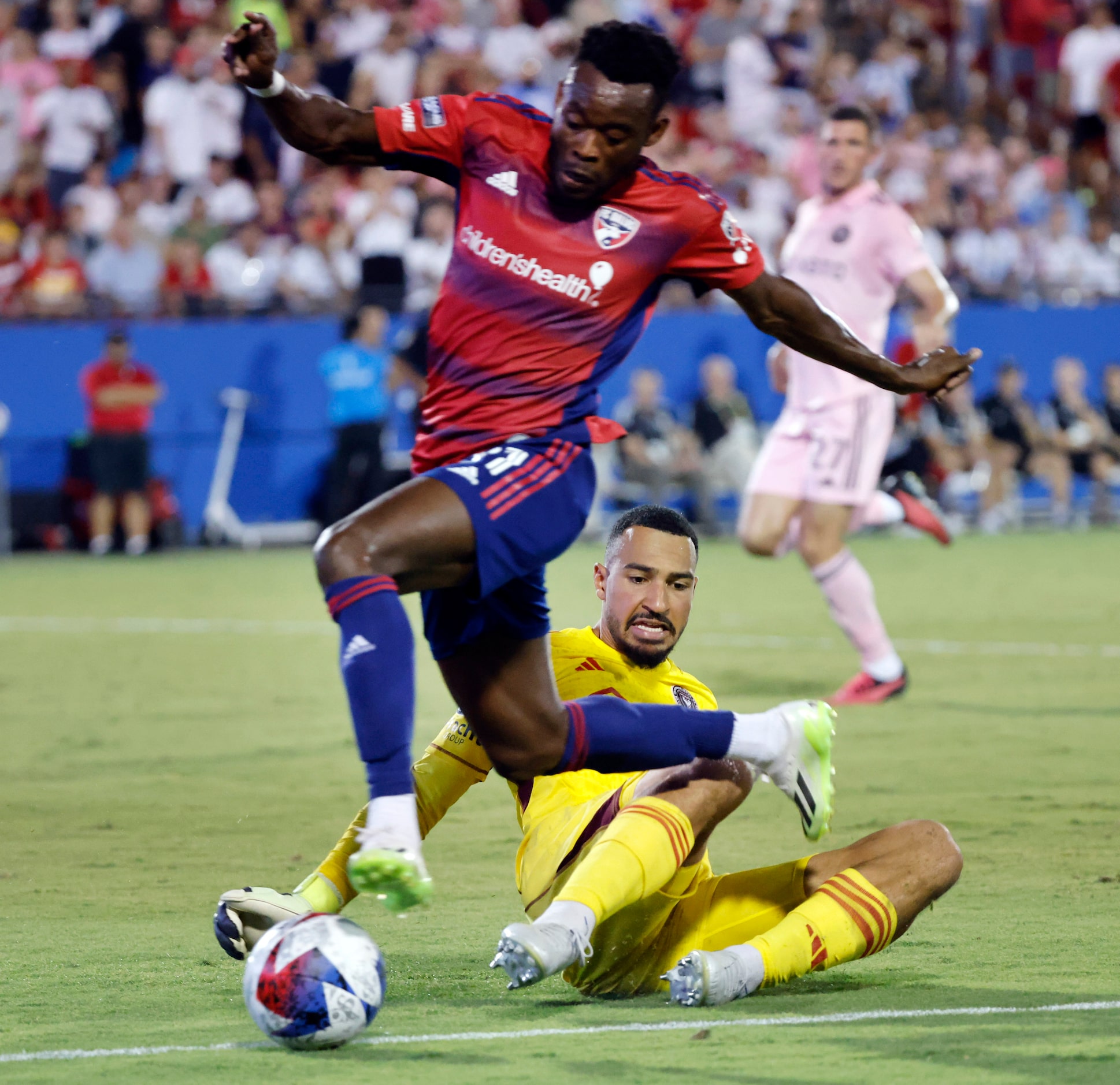 Inter Miami goalkeeper Drake Callender (1) slides and tackles FC Dallas’ Ansah Eugene (31)...