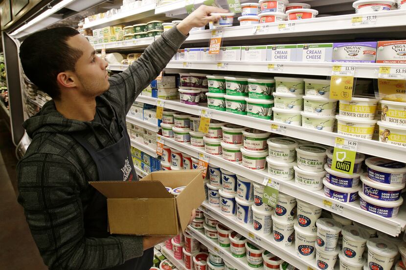  Christopher Quinones re-stocks cream cheese on a shelf at the Whole Foods Market in...