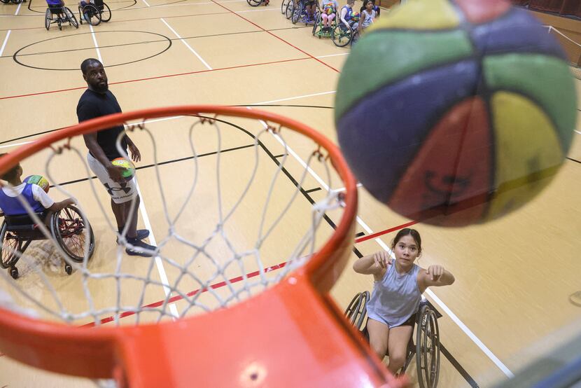 Mayli Gibson, 13, puts up a shot at a prep camp for the Dallas Junior Wheelchair Mavericks...