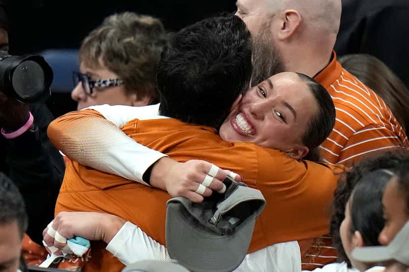 Texas's Madisen Skinner, right, celebrates after the team won the NCAA Division I women's...